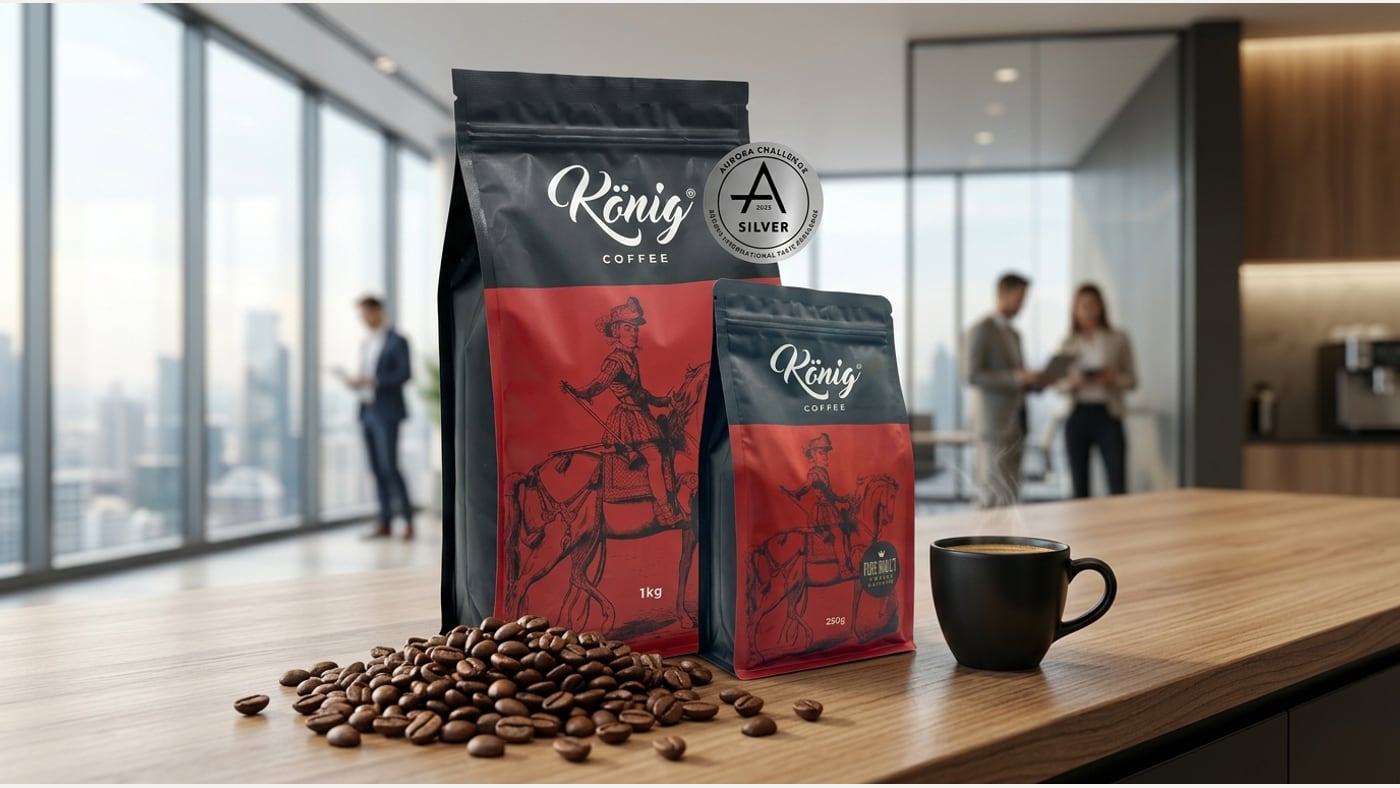 König Barista Espresso coffee bean bags beside a cappuccino in an office